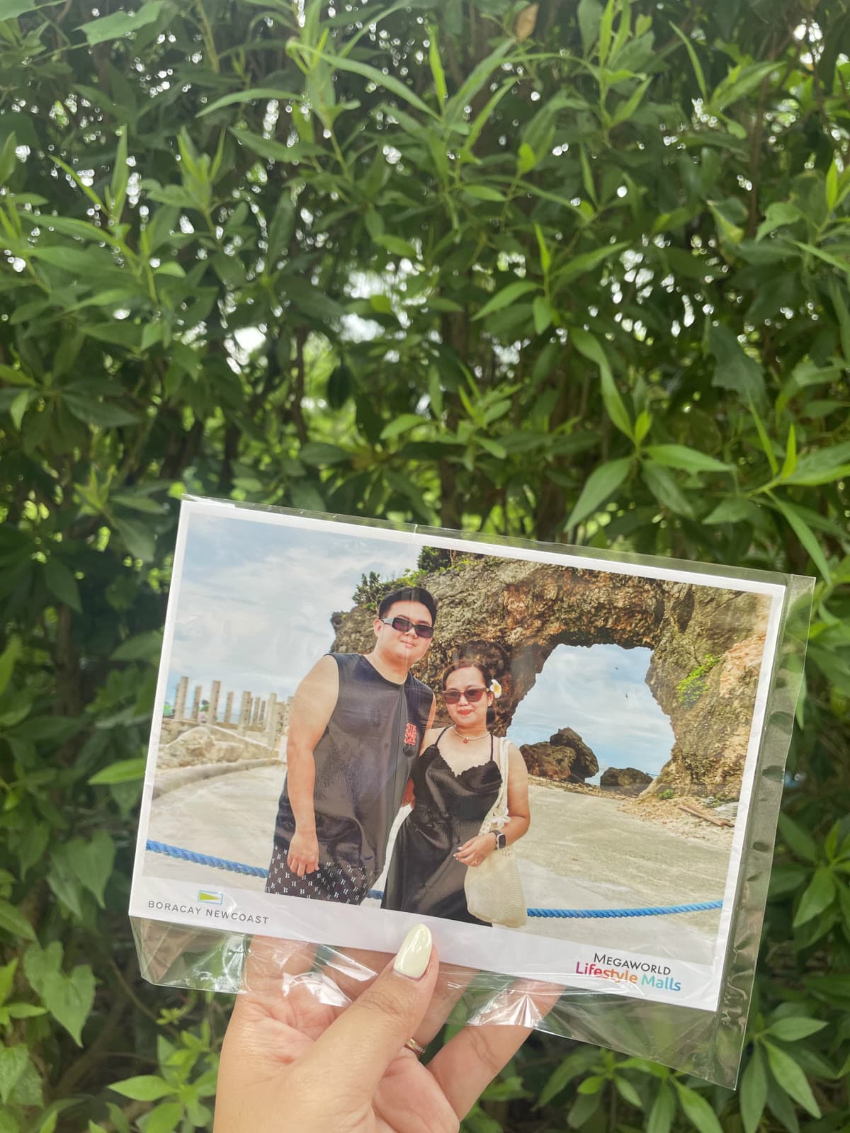 Holding a printed photo of us